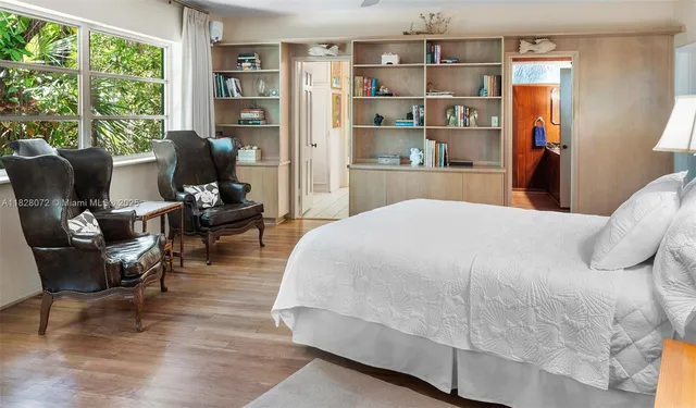 a bedroom with a bed a bookshelf and a bookshelf