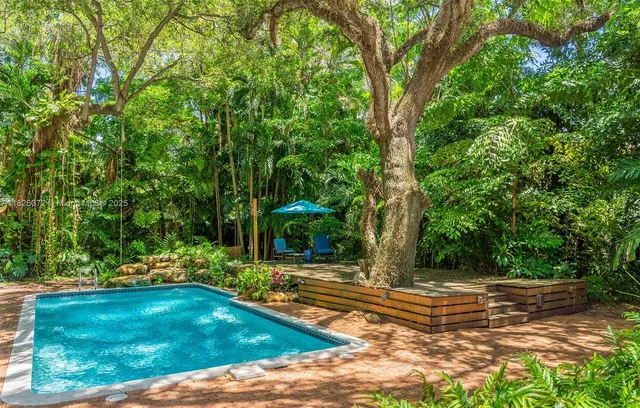 a view of a yard with large trees