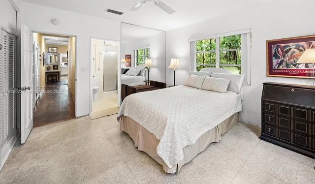 a bedroom with a bed dresser and a window