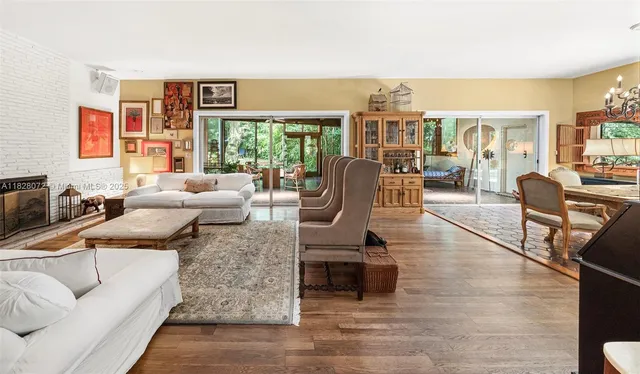 a living room with furniture and a floor to ceiling window