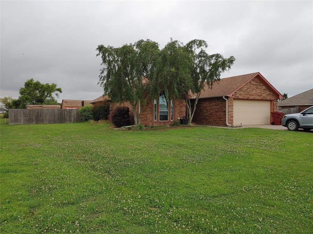 836 Airport Road Reno, TX 75462 - Photo 2 of 30 Brick exterior with a peaked roofline, an attached garage, and a large front lawn