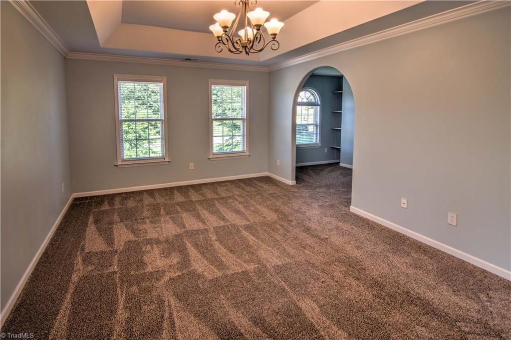 253 Ridge Drive Lexington, NC 27295 - Photo 17 of 27 Master bedroom has tray ceiling and adjoining sitting room.