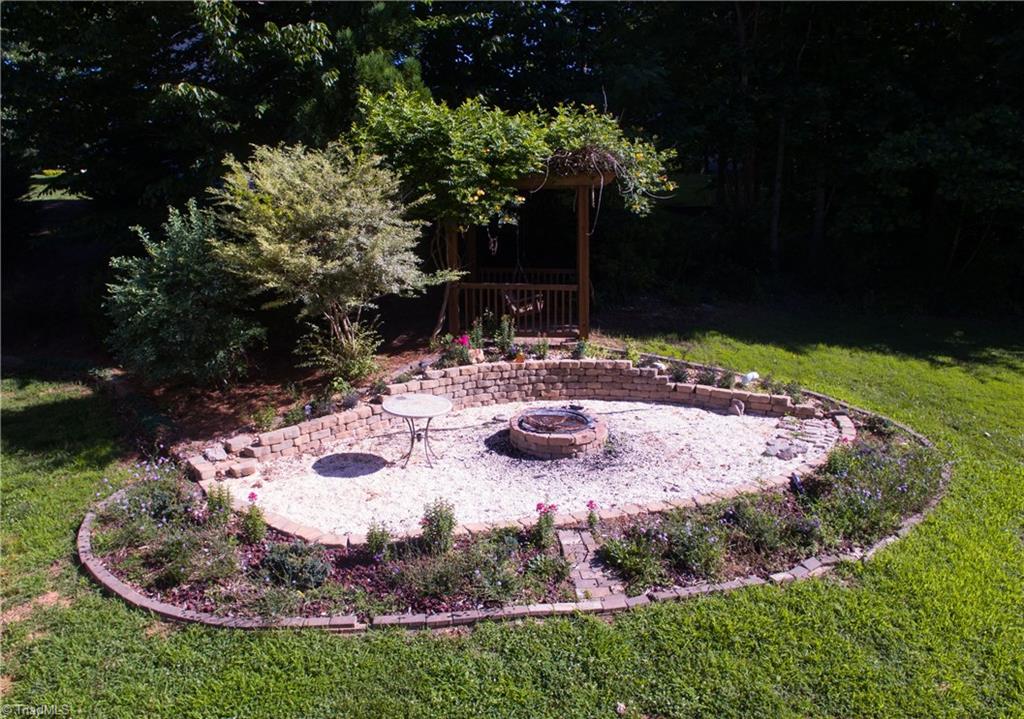 253 Ridge Drive Lexington, NC 27295 - Photo 5 of 27 Pergola with swing and fire pit.