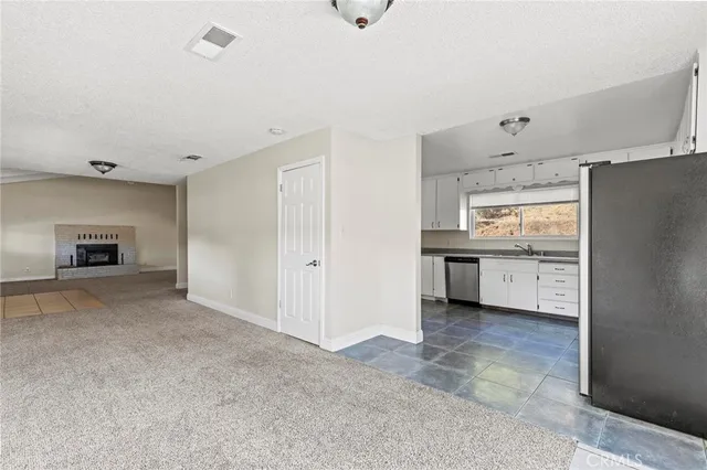 a kitchen with cabinets appliances and a window