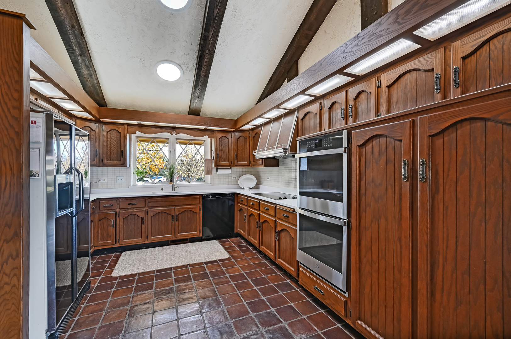 8402 Carriage Green Drive Darien, IL 60561 - Photo 9 of 39 a kitchen with stainless steel appliances granite countertop a stove a sink and dishwasher