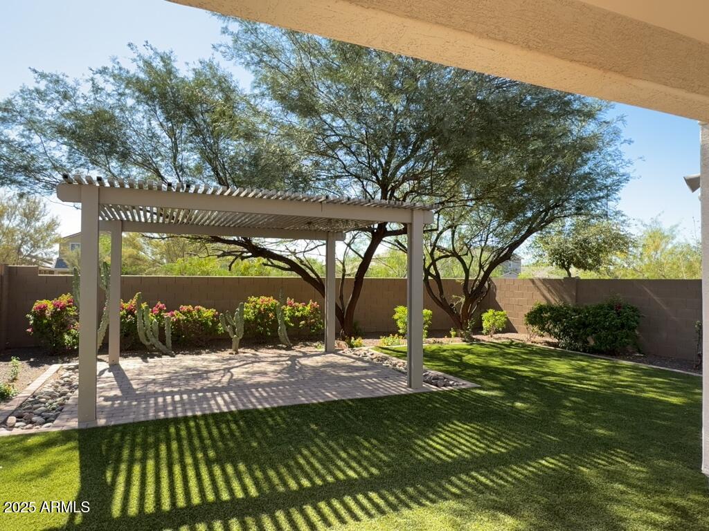9135 West Minnezona Avenue Phoenix, AZ 85037 - Photo 19 of 22 a view of a backyard
