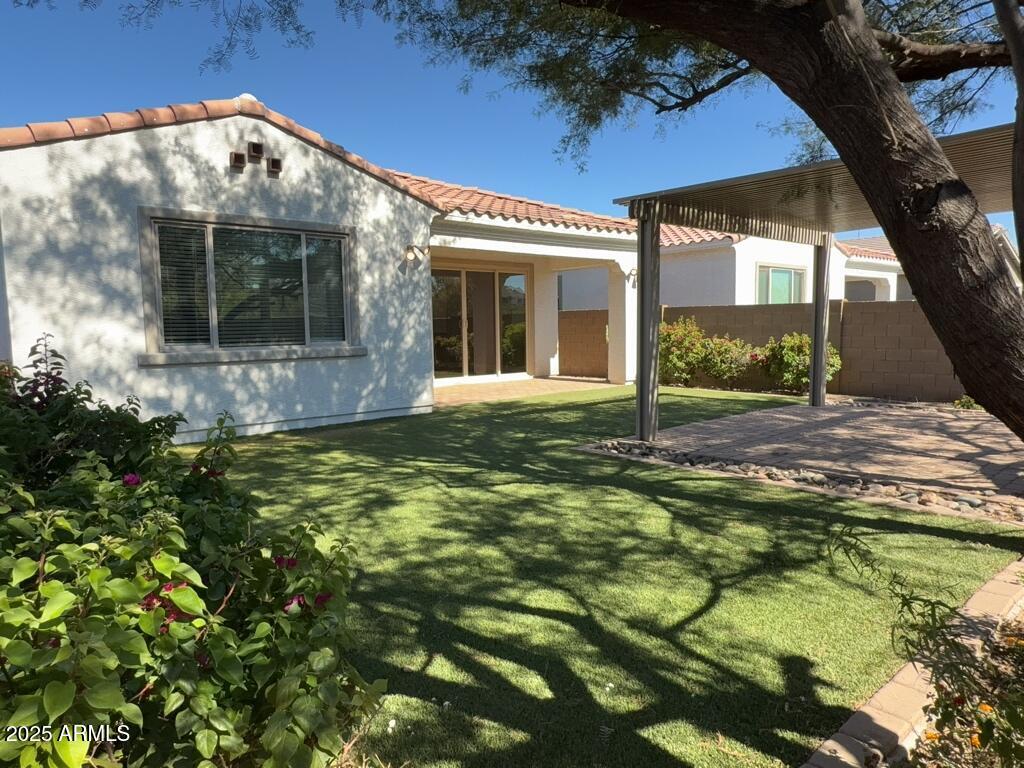 9135 West Minnezona Avenue Phoenix, AZ 85037 - Photo 20 of 22 a view of a house with a yard