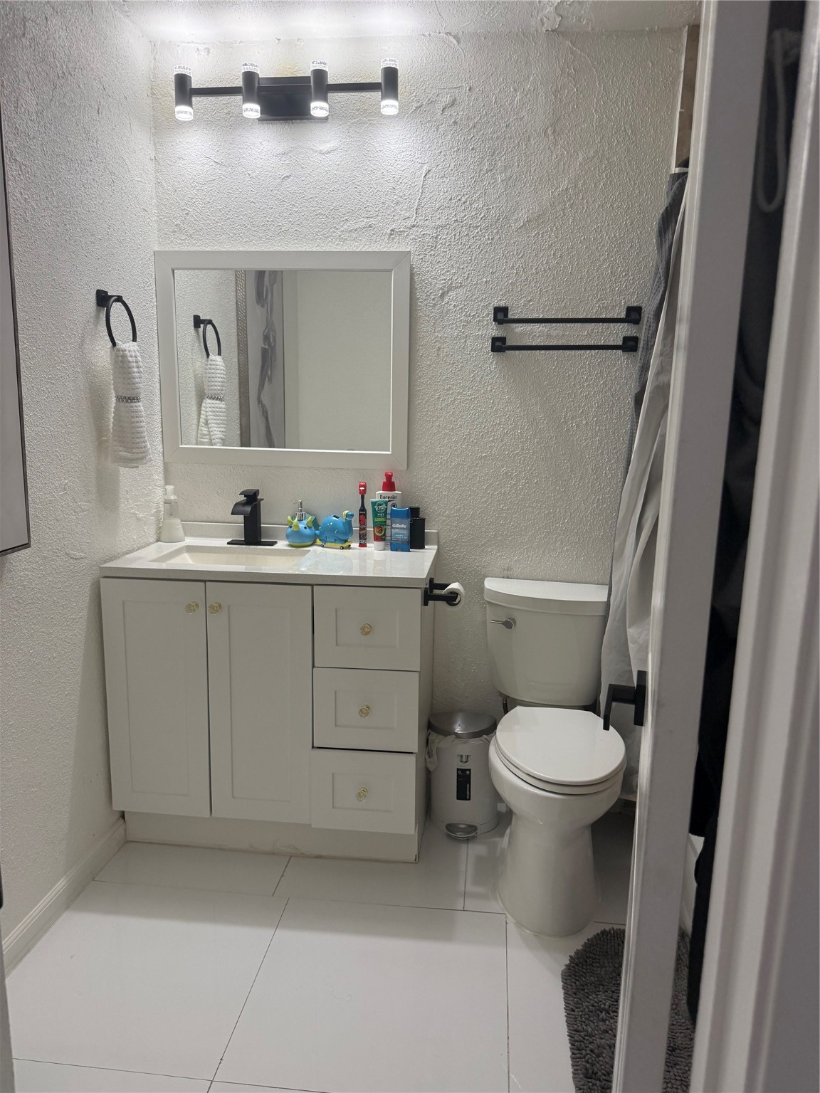 4622 Fitzwater Drive Spring, TX 77373 - Photo 12 of 16 a bathroom with a toilet sink vanity granite and mirror