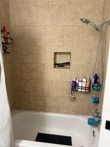 a bath room with a bath tub and a shower