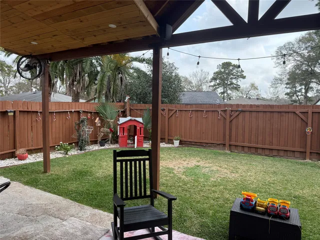 a view of a porch with furniture and garden
