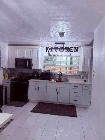 a kitchen with stainless steel appliances a refrigerator sink and stove