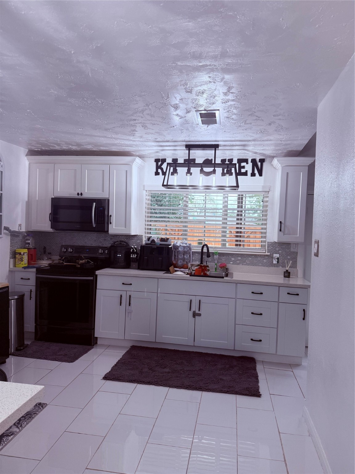 4622 Fitzwater Drive Spring, TX 77373 - Photo 5 of 16 a kitchen with stainless steel appliances a refrigerator sink and stove