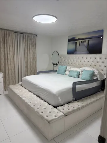 a bedroom with a bed and a couch