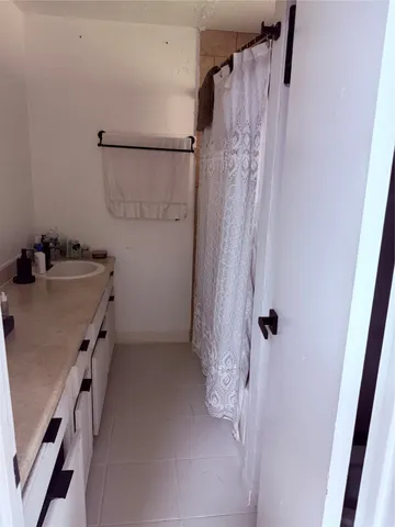 a bathroom with a shower and a sink