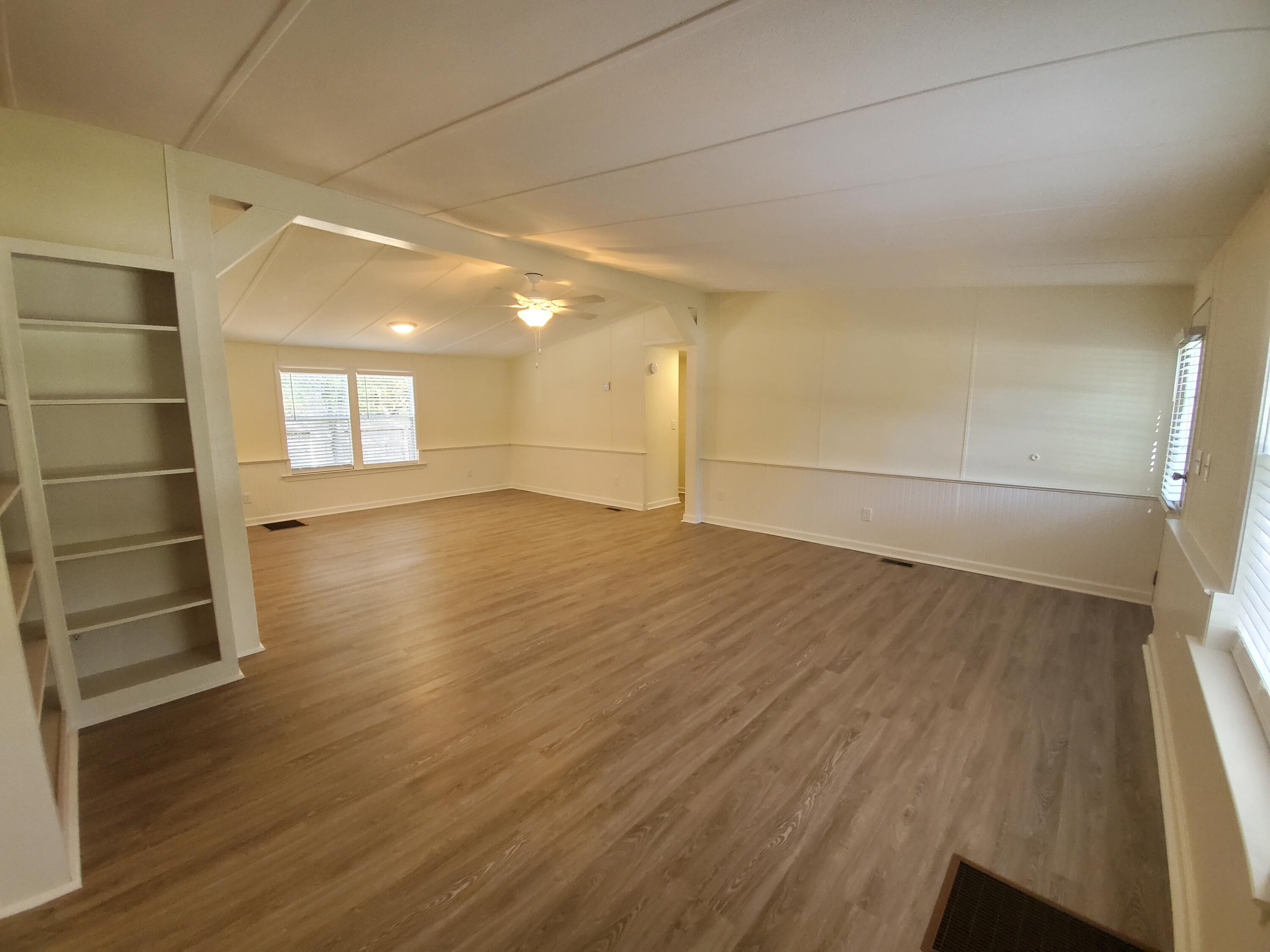 990 Chat Holley Road Santa Rosa Beach, FL 32459 - Photo 11 of 25 an empty room with wooden floor and windows