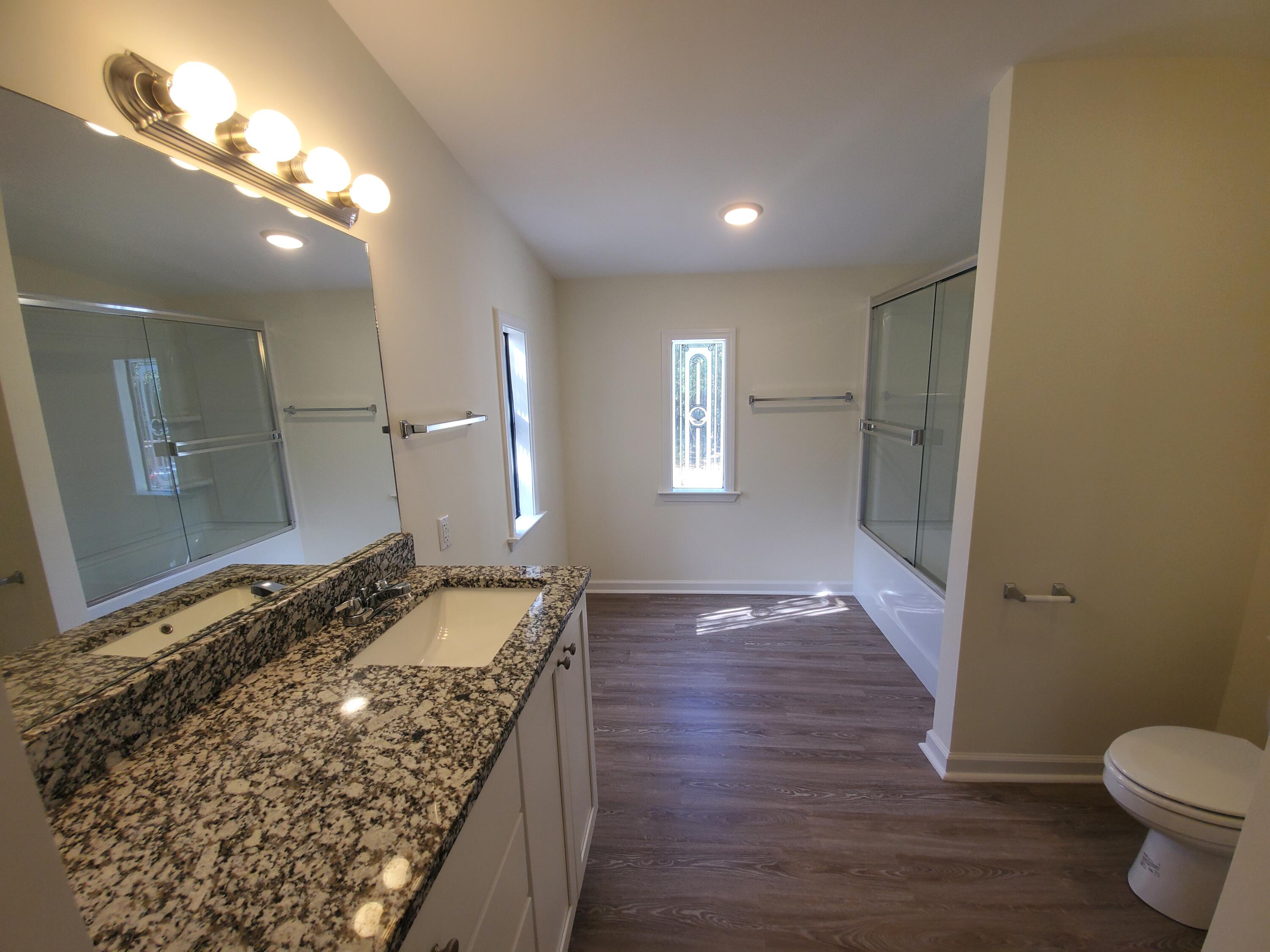 990 Chat Holley Road Santa Rosa Beach, FL 32459 - Photo 13 of 25 a bathroom with a granite countertop sink and a mirror