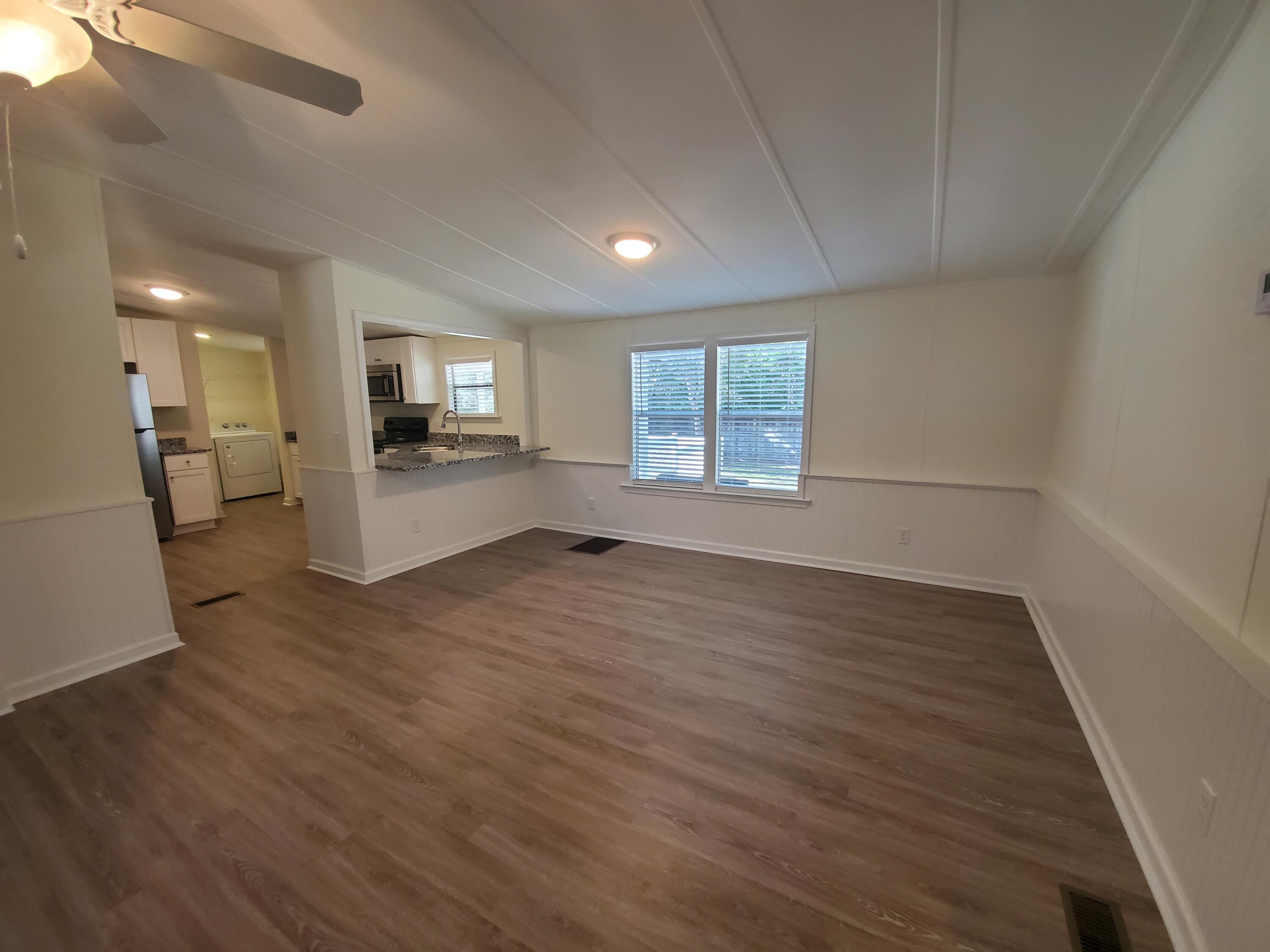 990 Chat Holley Road Santa Rosa Beach, FL 32459 - Photo 18 of 25 a view of empty room with wooden floor and windows