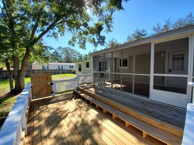 a view of a chairs and table on the wooden deck