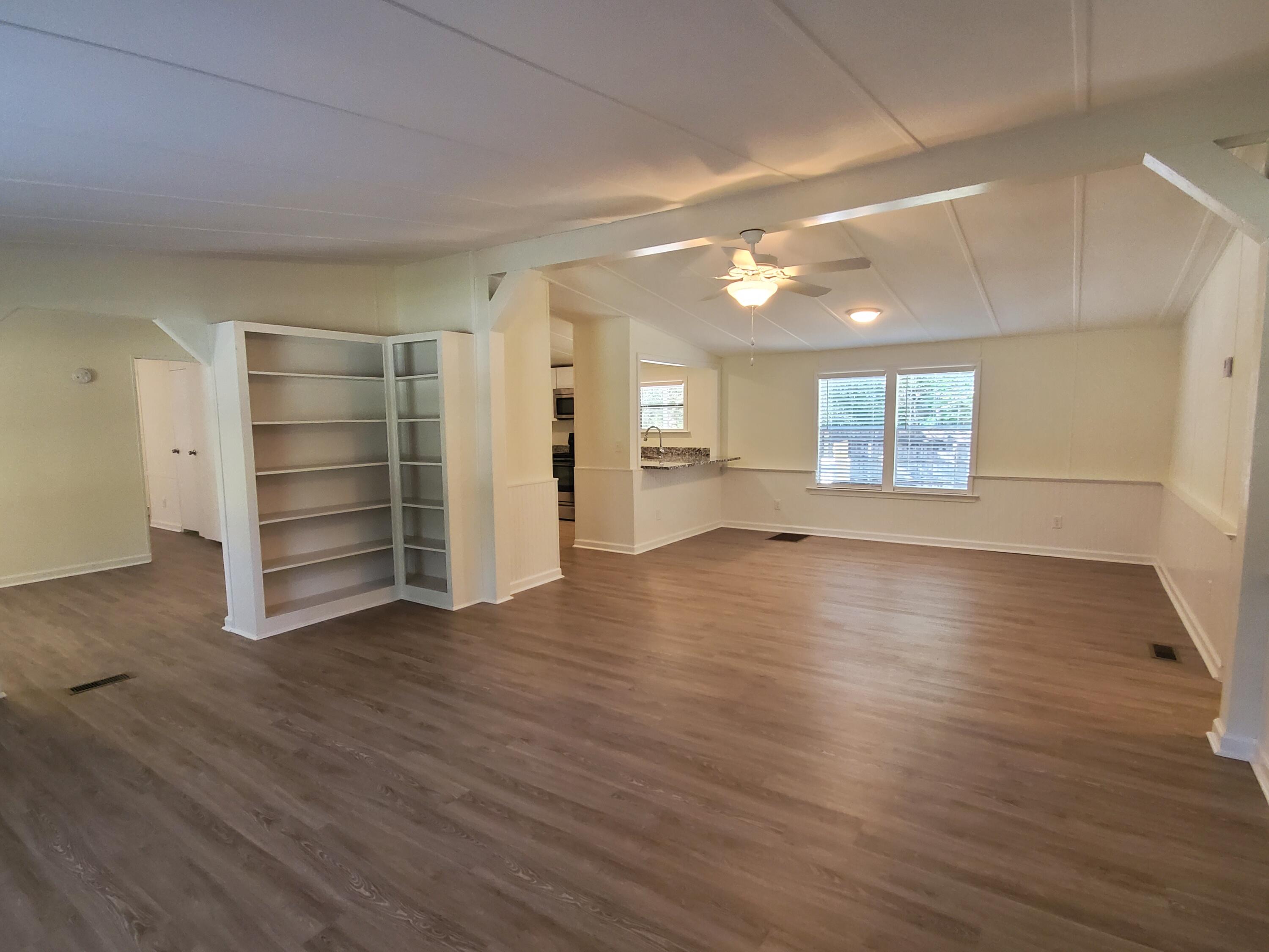 990 Chat Holley Road Santa Rosa Beach, FL 32459 - Photo 4 of 25 an empty room with wooden floor and windows