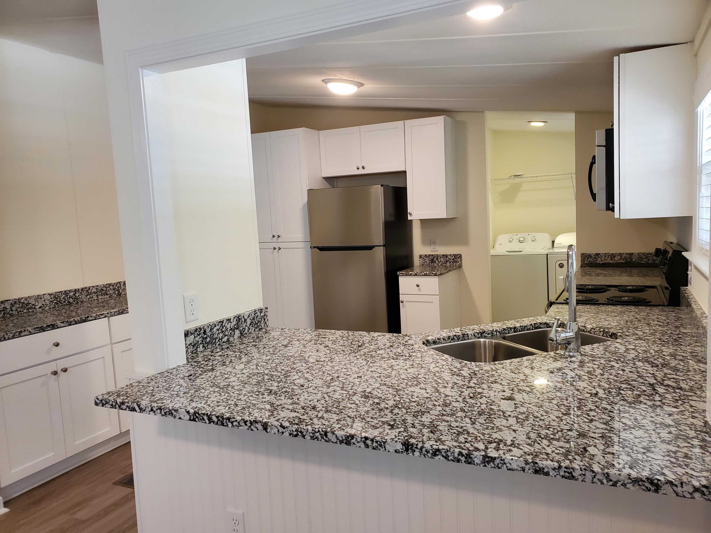 990 Chat Holley Road Santa Rosa Beach, FL 32459 - Photo 6 of 25 a kitchen with sink and refrigerator