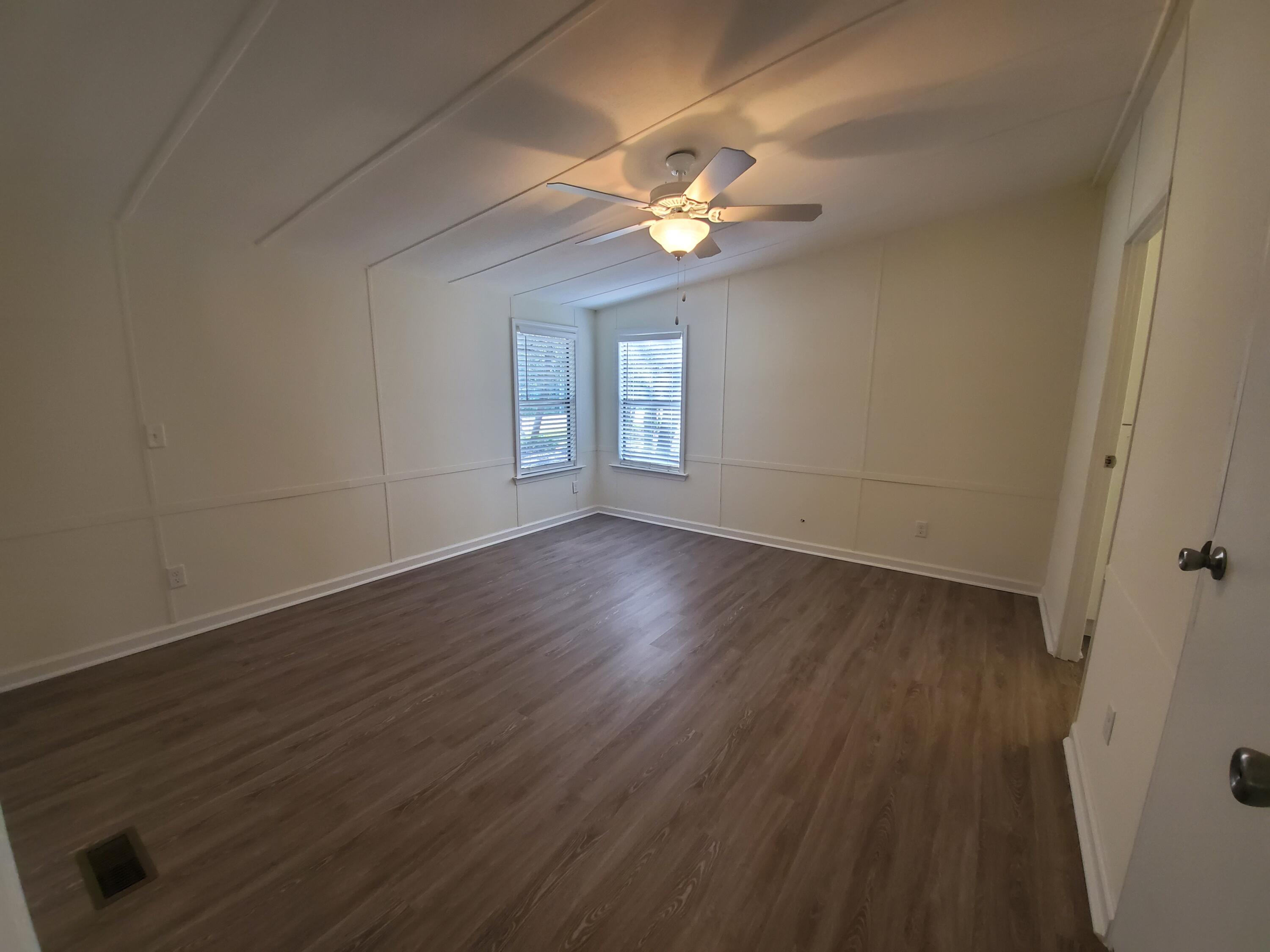 990 Chat Holley Road Santa Rosa Beach, FL 32459 - Photo 8 of 25 a view of an empty room with wooden floor and a window