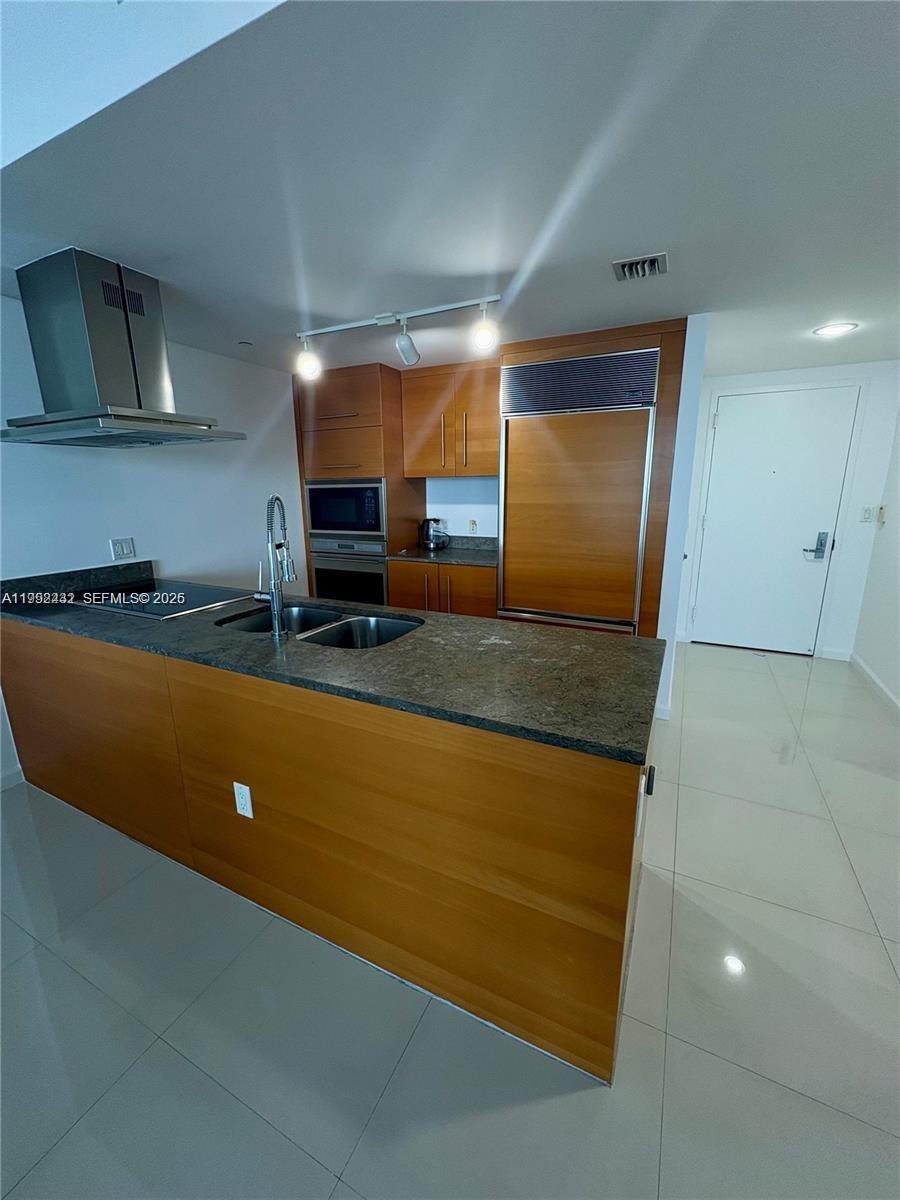 495 Brickell Avenue, Unit 3909 Miami, FL 33131 - Photo 4 of 11 a kitchen with stainless steel appliances granite countertop a sink a stove and a refrigerator