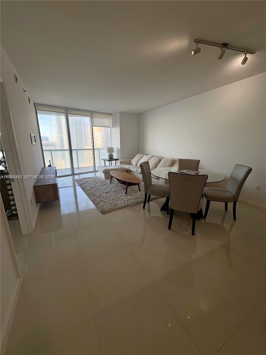 495 Brickell Avenue, Unit 3909 Miami, FL 33131 - Photo 6 of 11 a living room with furniture and a window