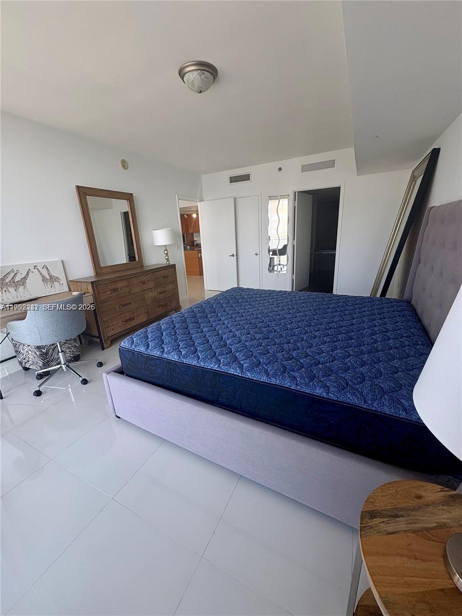 495 Brickell Avenue, Unit 3909 Miami, FL 33131 - Photo 9 of 11 a bedroom with a bed and window