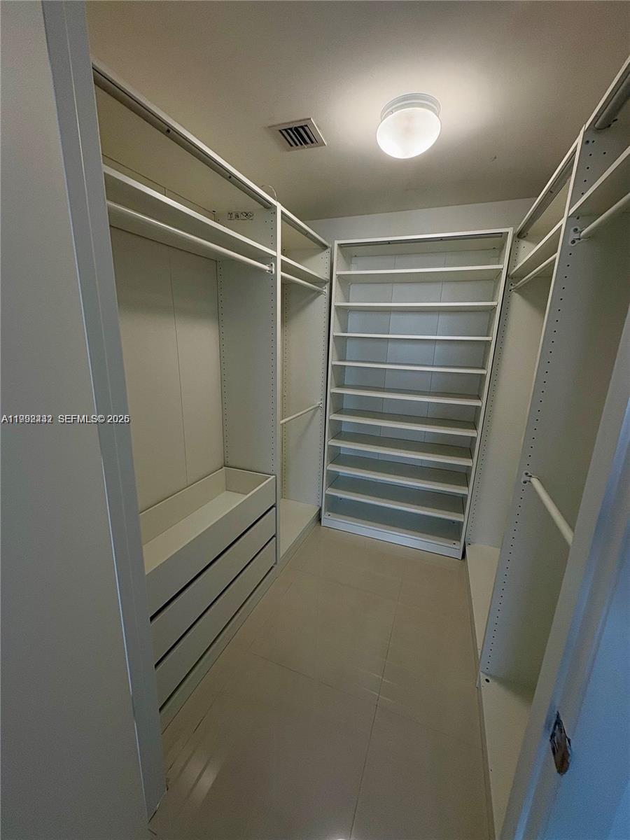 495 Brickell Avenue, Unit 3909 Miami, FL 33131 - Photo 10 of 11 a view of walk in closet with empty racks