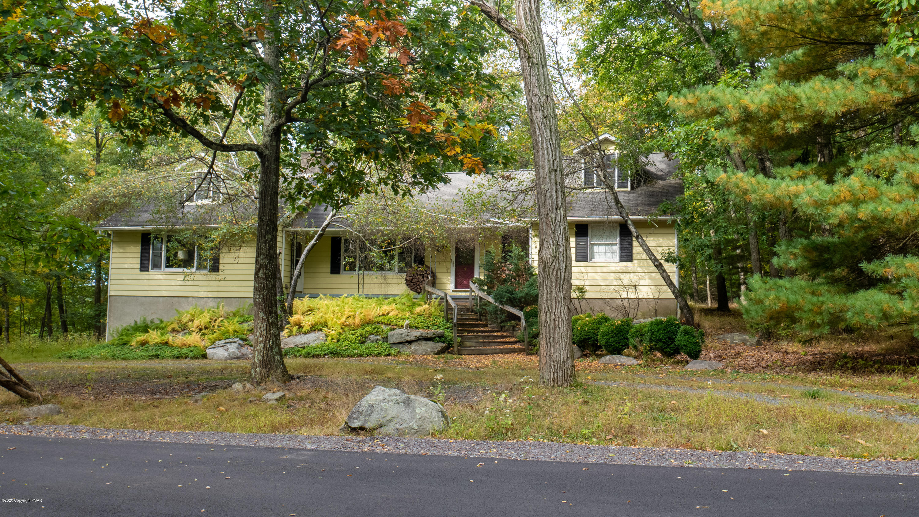 a front view of a house with garden