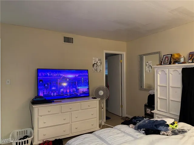 a bedroom with a bed and a dresser