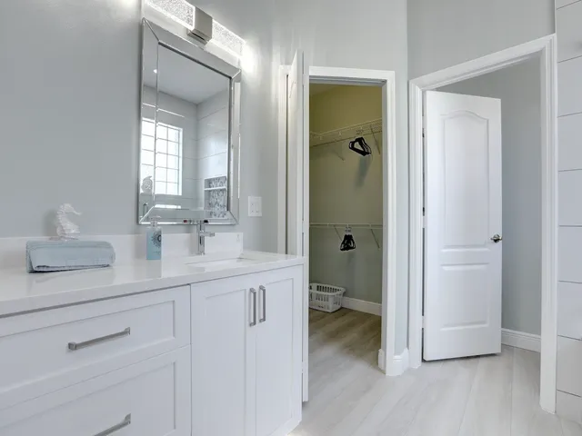 a bedroom with bed and a chandelier