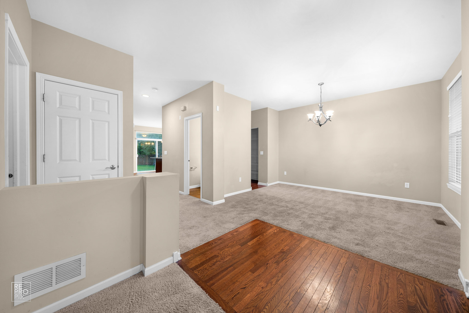 2218 Surrey Street Sycamore, IL 60178 - Photo 2 of 18 an empty room with wooden floor and bathroom view