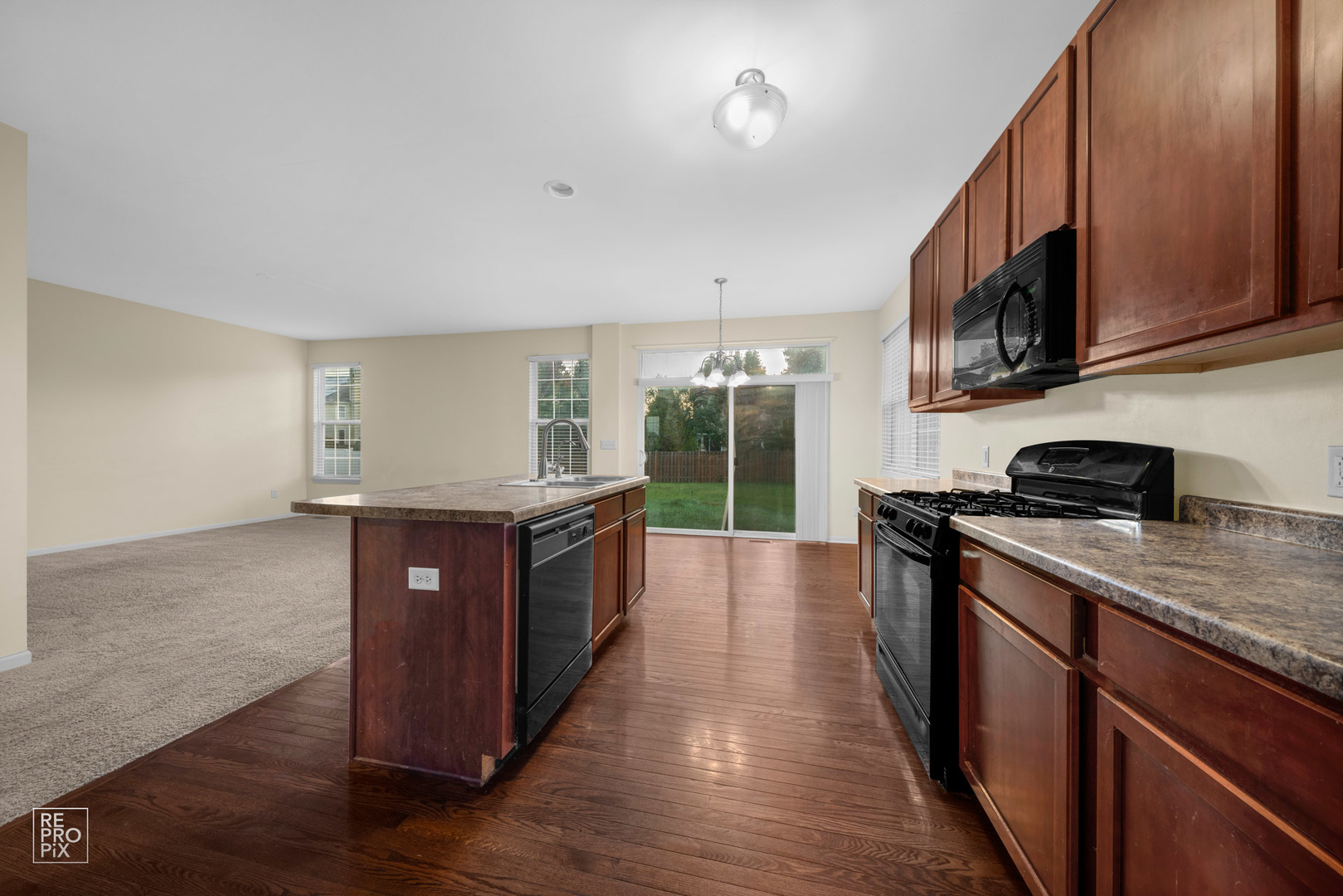 2218 Surrey Street Sycamore, IL 60178 - Photo 4 of 18 a kitchen with stainless steel appliances granite countertop a stove a sink and a refrigerator