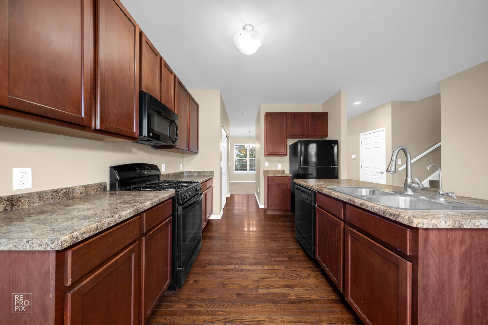 2218 Surrey Street Sycamore, IL 60178 - Photo 5 of 18 a kitchen with stainless steel appliances granite countertop a sink stove microwave and cabinets