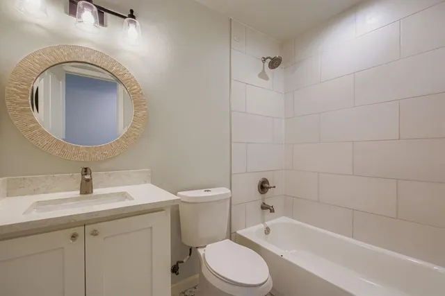 a bathroom with a toilet a sink and bathtub