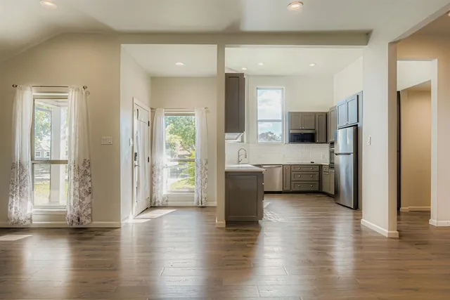 a view of a kitchen cabinets and a wooden floor