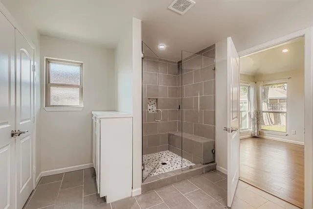 a bathroom with a glass shower door
