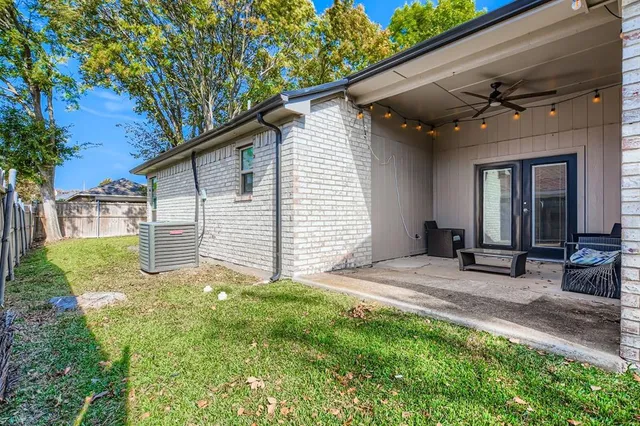 a view of a house with backyard and sitting area