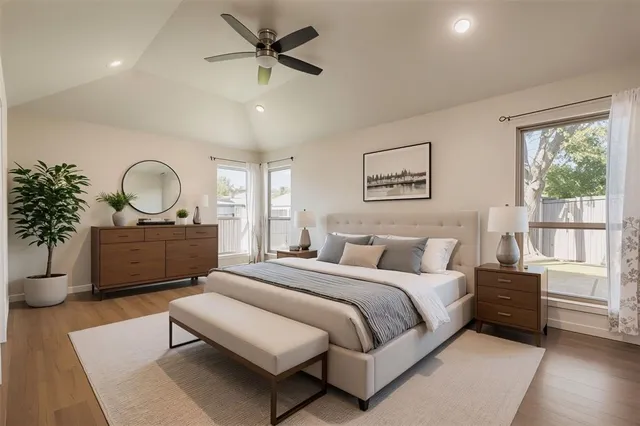 a bedroom with a bed mirror and window