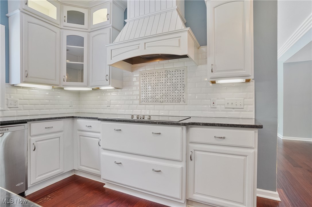 1453 Prospect Road Hudson, OH 44236 - Photo 11 of 50 Kitchen featuring dark wood-style floors, stainless steel dishwasher, glass insert cabinets, and tasteful backsplash