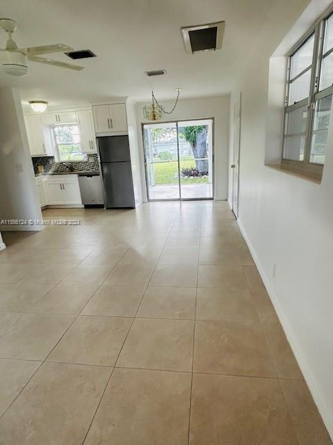 225 Davis Road Palm Springs, FL 33461 - Photo 3 of 19 a view of a kitchen with a sink and a large window