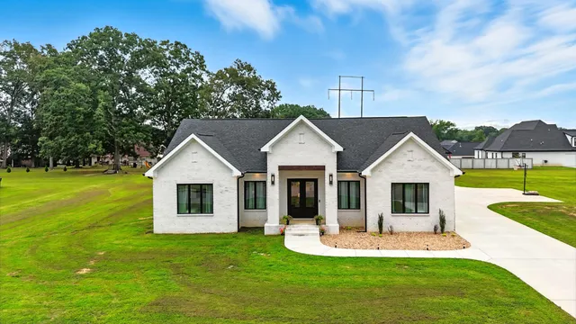 a view of a house with a yard patio and swimming pool
