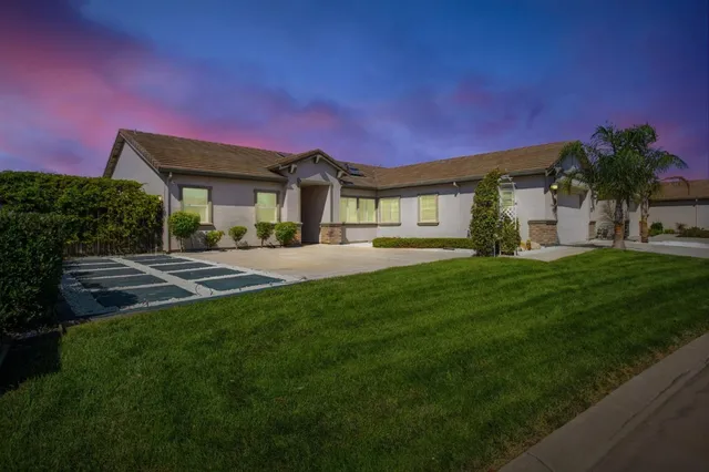 a front view of a house with a yard