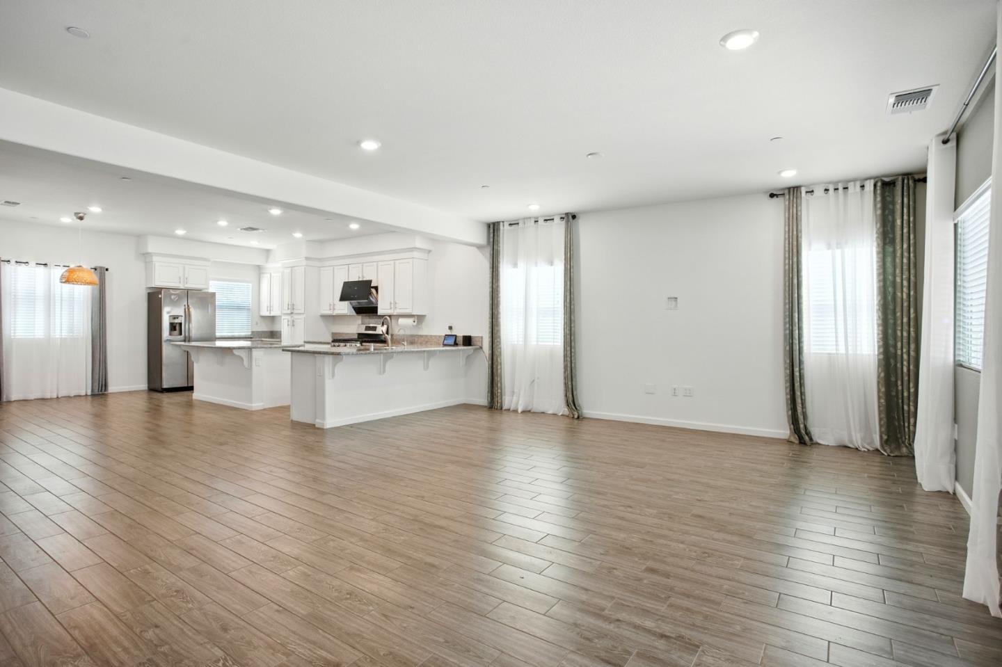 2061 Doncaster Court Olivehurst, CA 95961 - Photo 16 of 46 a view of a kitchen with a refrigerator and a stove top oven