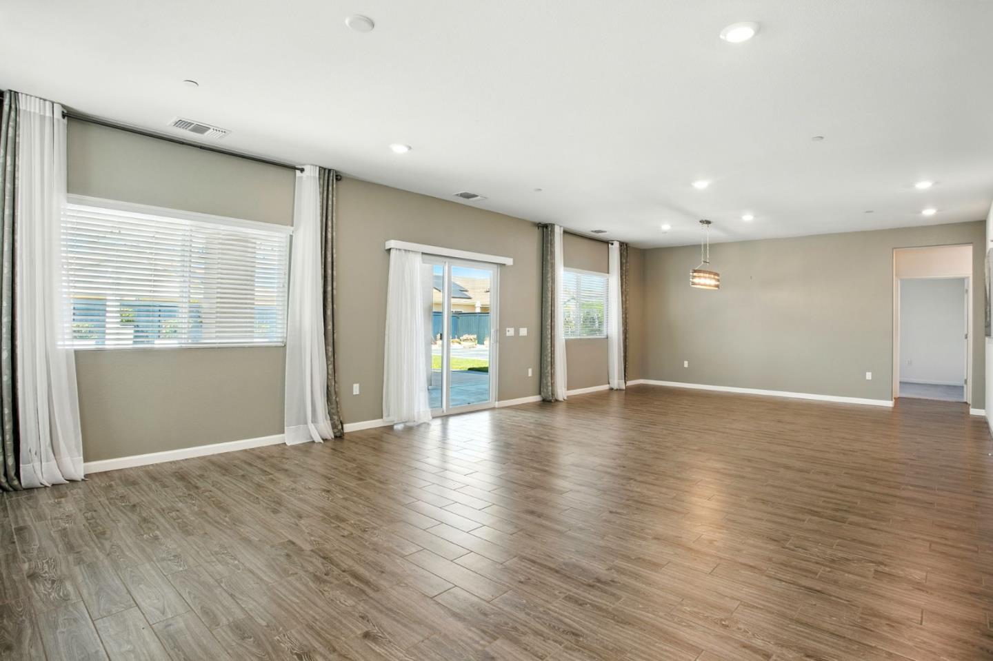 2061 Doncaster Court Olivehurst, CA 95961 - Photo 18 of 46 an empty room with wooden floor and windows