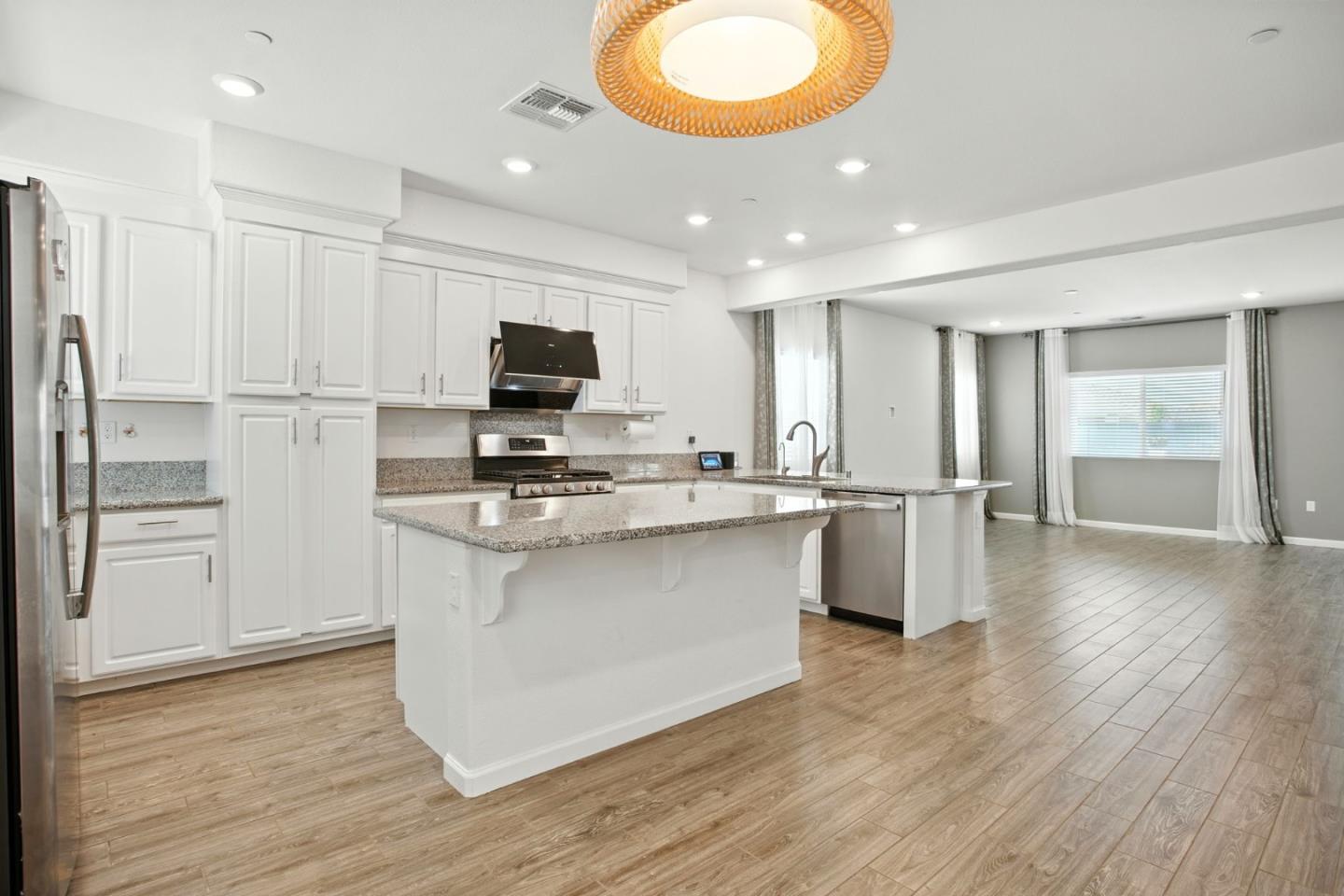2061 Doncaster Court Olivehurst, CA 95961 - Photo 22 of 46 a kitchen with stainless steel appliances granite countertop a stove a sink and a refrigerator