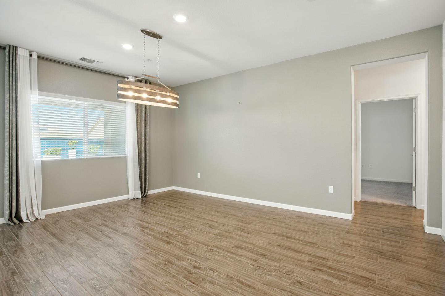 2061 Doncaster Court Olivehurst, CA 95961 - Photo 23 of 46 an empty room with wooden floor and windows