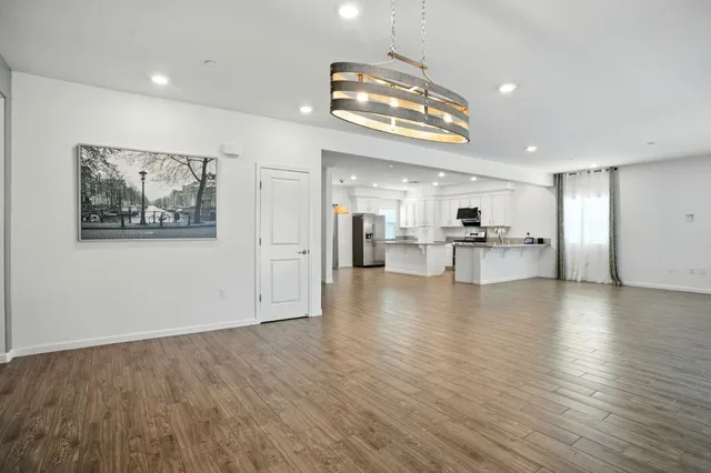 a view of a kitchen with a sink and a refrigerator