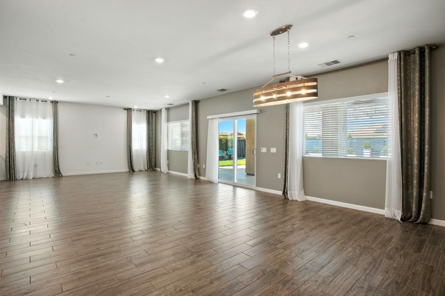 2061 Doncaster Court Olivehurst, CA 95961 - Photo 25 of 46 an empty room with wooden floor and windows